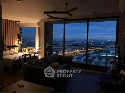 Modern living room with stunning city view through large windows at dusk.