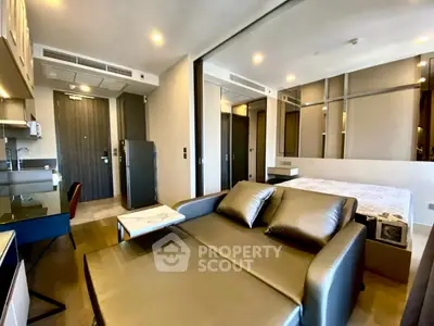 Modern studio apartment with sleek furnishings and open layout, featuring a cozy living area and stylish bedroom.