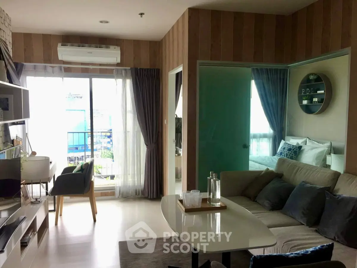 Modern living room with stylish decor and large windows offering city views