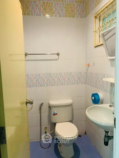 Compact bathroom with modern fixtures and colorful tile accents