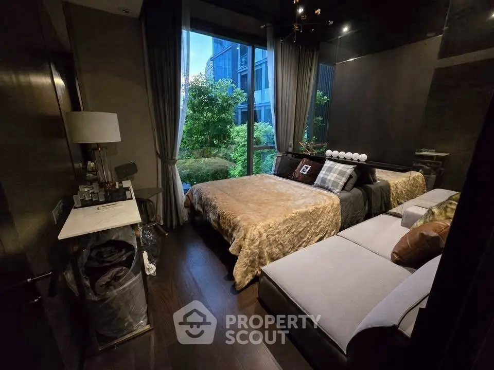 Luxurious bedroom with elegant decor and garden view, featuring plush bedding and modern furnishings.