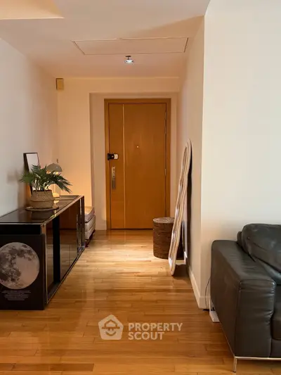 Stylish apartment entrance with wooden flooring and modern decor