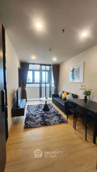 Modern living room with stylish decor and large window view