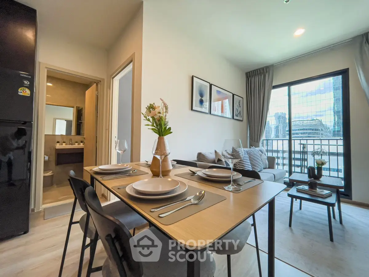 Modern living room with dining area and city view balcony
