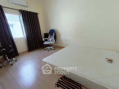 Spacious bedroom with minimalist decor and natural light