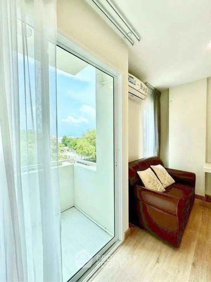 Bright living room with balcony access and cozy seating area
