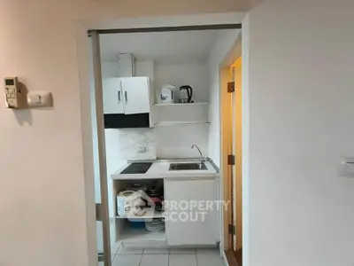 Compact kitchen with modern appliances and open shelving