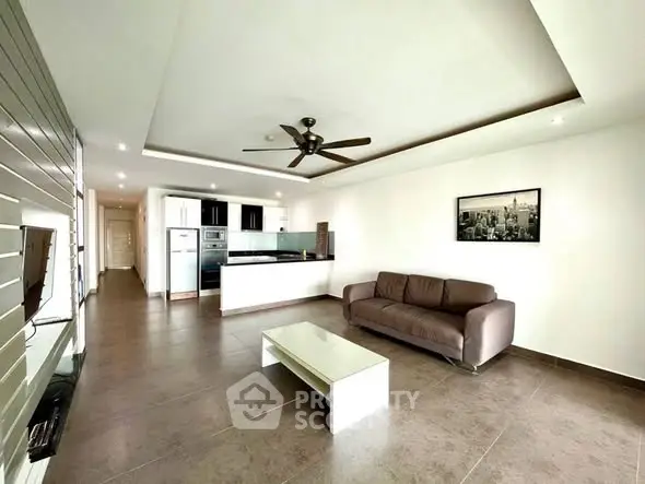 Spacious modern living room with open kitchen and sleek design