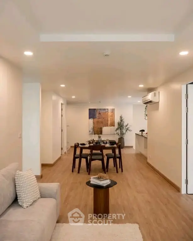 Spacious modern living room with elegant dining area and open kitchen layout.