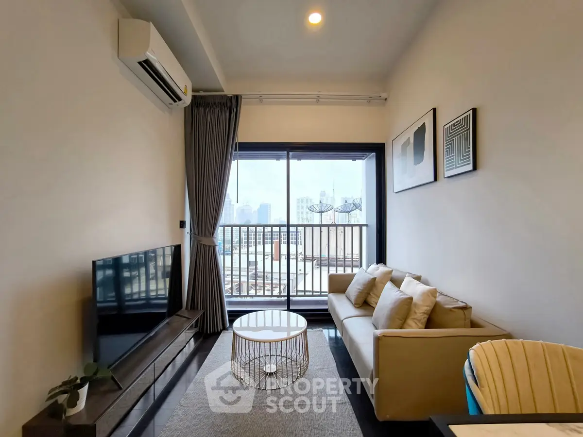 Modern living room with balcony view, sleek furniture, and natural light.