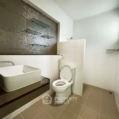 Modern bathroom with sleek design and glass shelving
