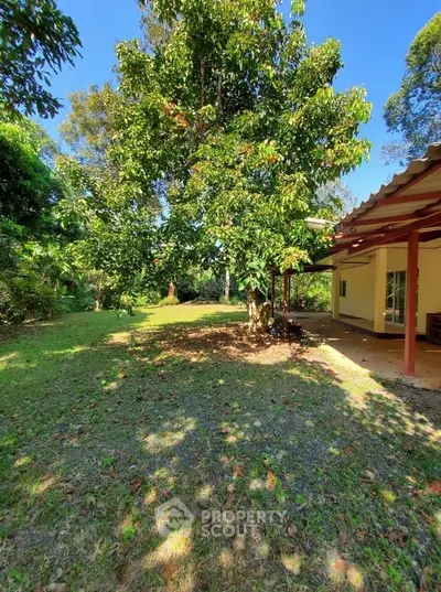Charming garden view with lush greenery and cozy patio in a serene residential setting.