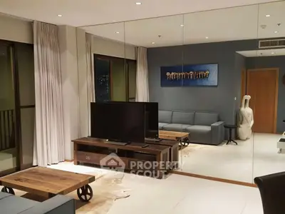 Modern living room with stylish decor and large mirror wall