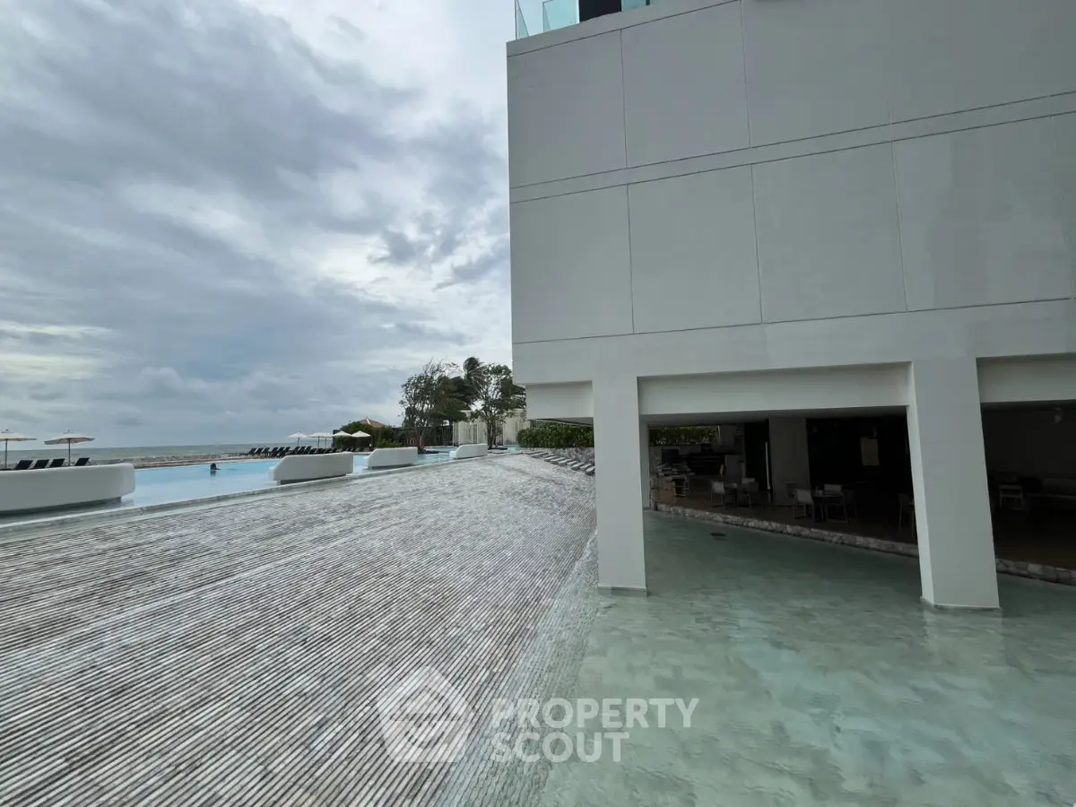 Luxurious beachfront property with stunning infinity pool and modern architecture.