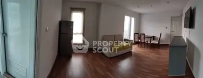 Spacious living room with modern furniture and wooden flooring in a bright apartment.