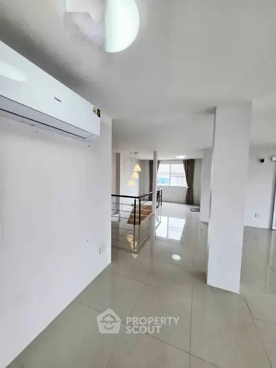 Spacious modern interior with sleek design and abundant natural light, featuring a stylish air conditioning unit.