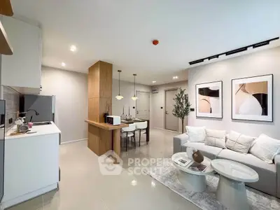 Modern open-plan living room with stylish decor and kitchen area