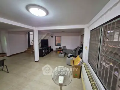 Spacious living room with modern decor and ample natural light