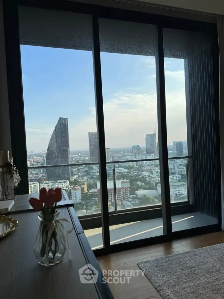 Stunning high-rise apartment view with floor-to-ceiling windows overlooking city skyline and modern decor.