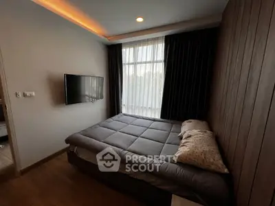 Cozy bedroom with modern decor, wall-mounted TV, and large window with curtains.