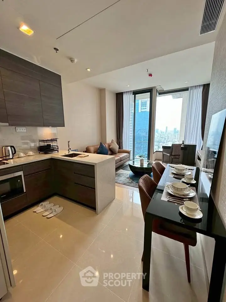 Modern open-layout kitchen and living room with city view, stylish furniture, and dining area.