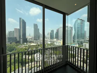Stunning cityscape view from a modern high-rise balcony with floor-to-ceiling windows.