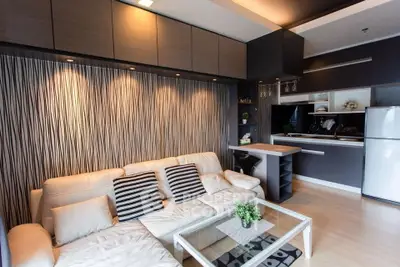 Modern living room with stylish kitchen and cozy seating area