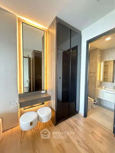 Modern bedroom with stylish vanity and sleek bathroom view