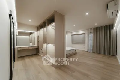 Spacious modern bedroom with walk-in closet and elegant lighting