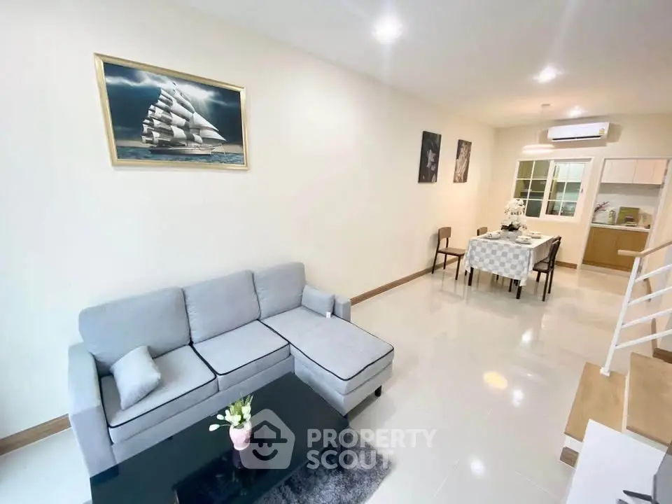 Spacious living room with modern decor and open dining area