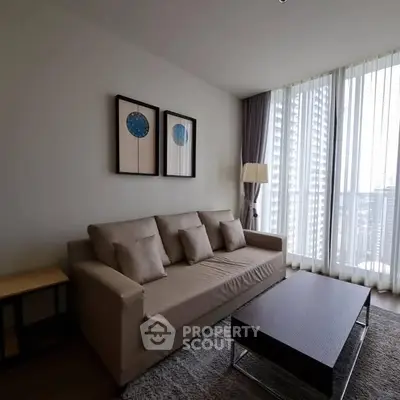 Modern living room with cozy sofa and city view through large windows