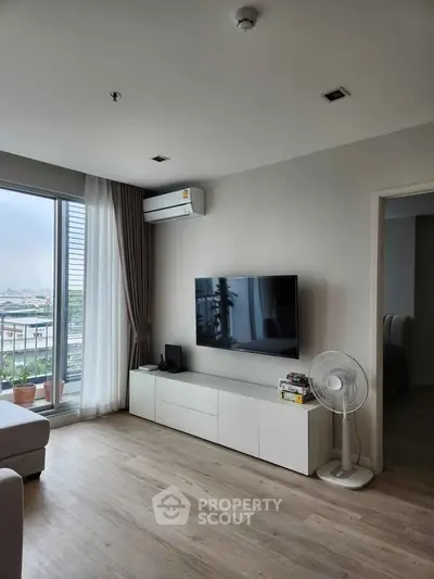 Modern living room with large window and sleek TV setup