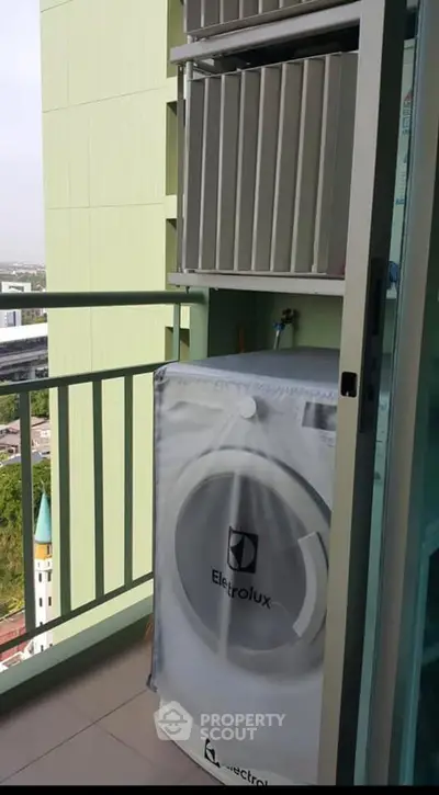 Modern balcony with Electrolux washing machine and city view, perfect for urban living convenience.