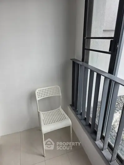 Minimalist balcony with modern chair and sleek railing design