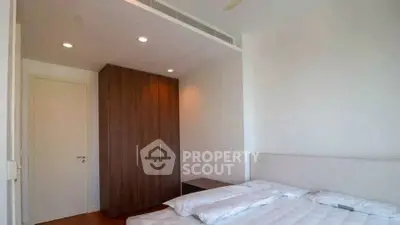 Modern bedroom with minimalist design and wooden wardrobe