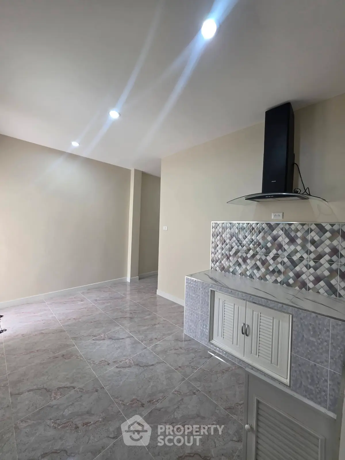 Spacious modern kitchen with sleek tile flooring and stylish backsplash