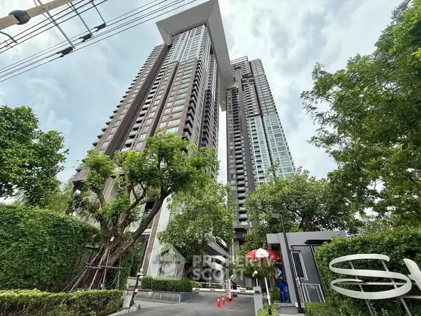 Stunning high-rise residential building with lush greenery and modern architecture.