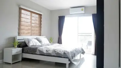 Bright and modern bedroom with large window and stylish decor