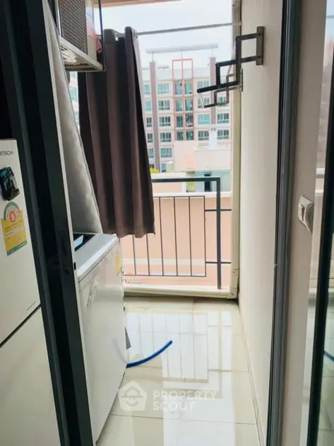 Compact balcony with city view and washing machine setup