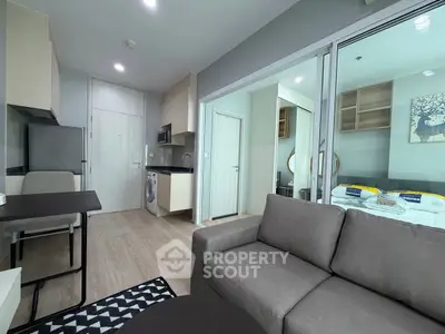 Modern apartment interior with open layout, featuring a cozy living area, compact kitchen, and stylish bedroom.