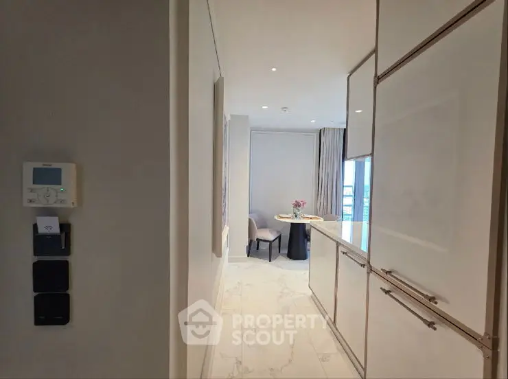 Modern open-plan living room with sleek design and elegant staircase