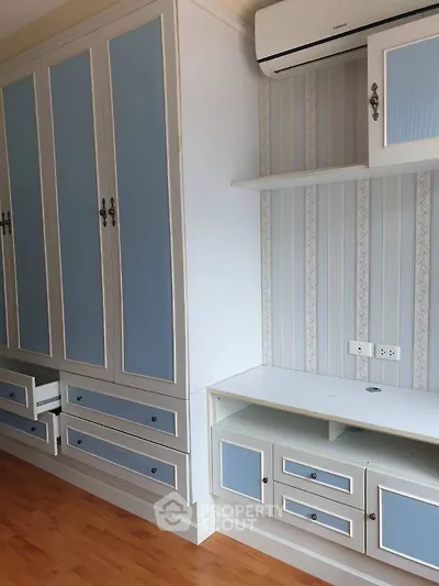 Stylish bedroom with built-in wardrobe and air conditioning unit