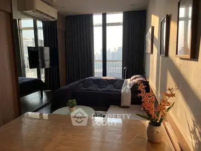 Modern bedroom with city view and stylish decor, featuring large windows and cozy ambiance.