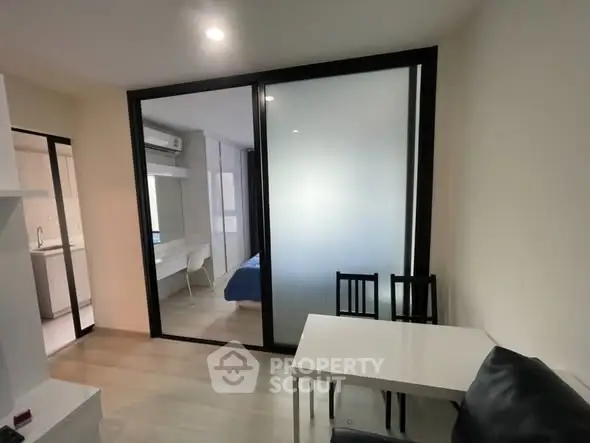 Modern apartment interior with sliding glass doors and cozy dining area.