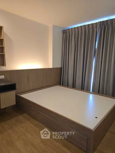 Modern bedroom with sleek wooden furniture and elegant curtains