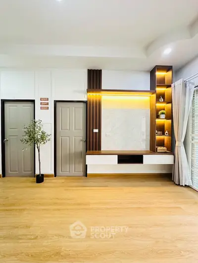 Modern living room with stylish built-in shelving and elegant wood flooring