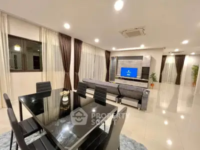 Spacious modern living room with sleek dining area and stylish decor.