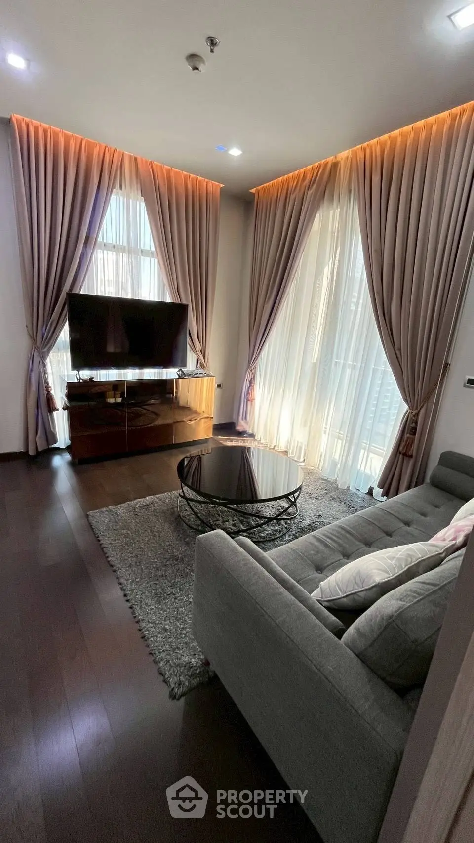 Luxurious living room with elegant curtains, modern furniture, and ambient lighting.