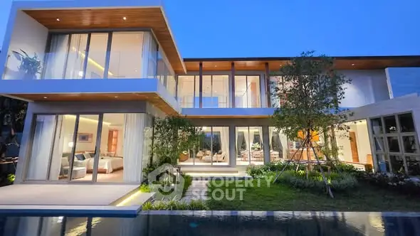 Luxurious modern villa with stunning architecture and lush garden view at dusk.