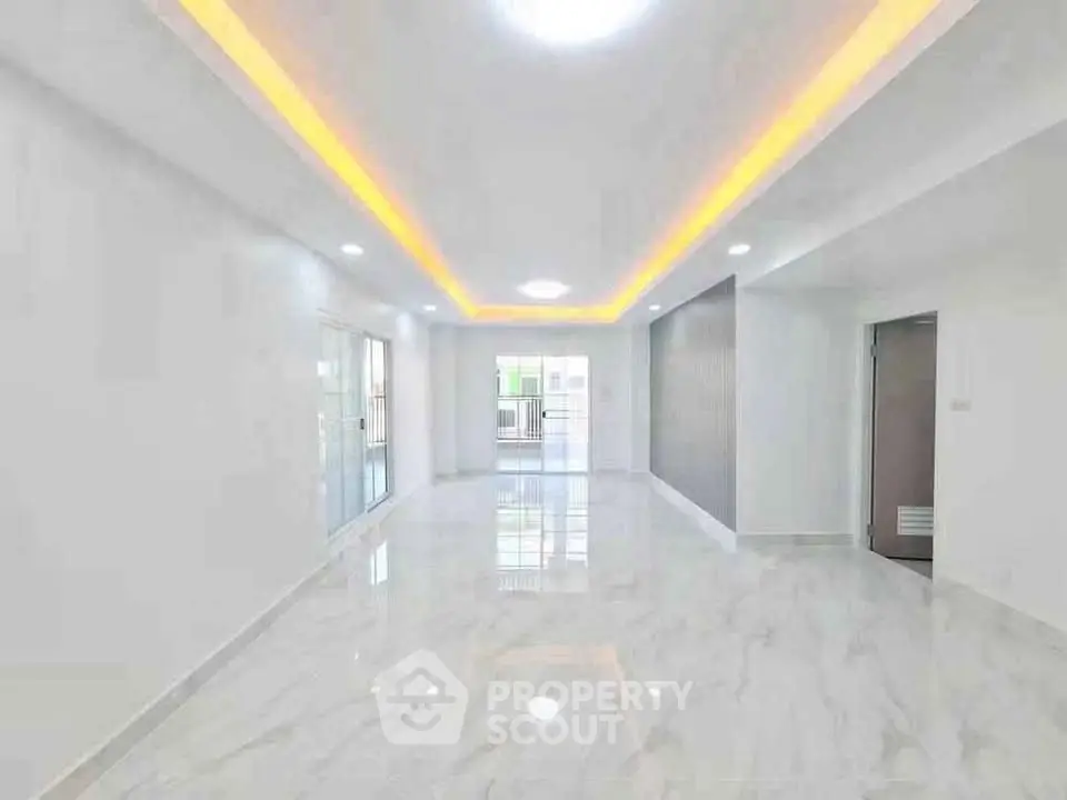 Spacious modern living room with marble flooring and ambient lighting